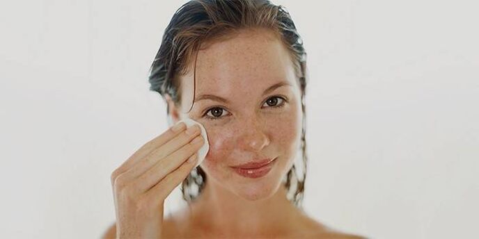 applying oil to the skin of the face to rejuvenate it